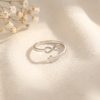 Zilveren verstelbare ring met kruisje en infinity-symbool